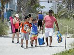 Residents flock to Florida’s Cocoa Beach as it reopens for sun tanning