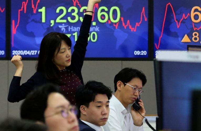 Asia shares mixed, eyeing economies reopening, central banks