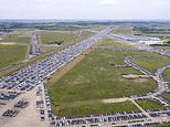 Thousands of unwanted new and used motors are stored on airfield as coronavirus slump hits economy 