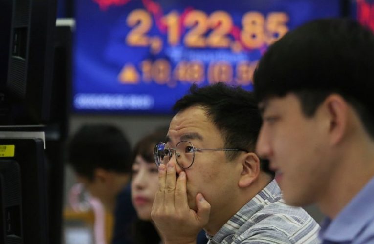 Stocks sink as virus cases jump, forcing states to backtrack