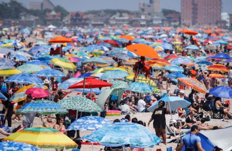 Crowds flock to beaches on July 4th weekend despite warnings and surge in Covid-19 cases