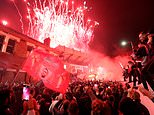 Liverpool fans throw smoke bombs as they ignore police advice and gather at Anfield