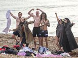 Brave swimmers enjoy ice-cold beer as droves sip takeaway drinks on 8C Brighton beach