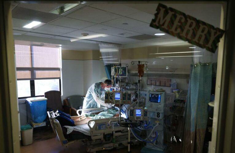 About 200,000 people have tested positive every day for two straight weeks in the United States, a toll that has led to record numbers of people hospitalized