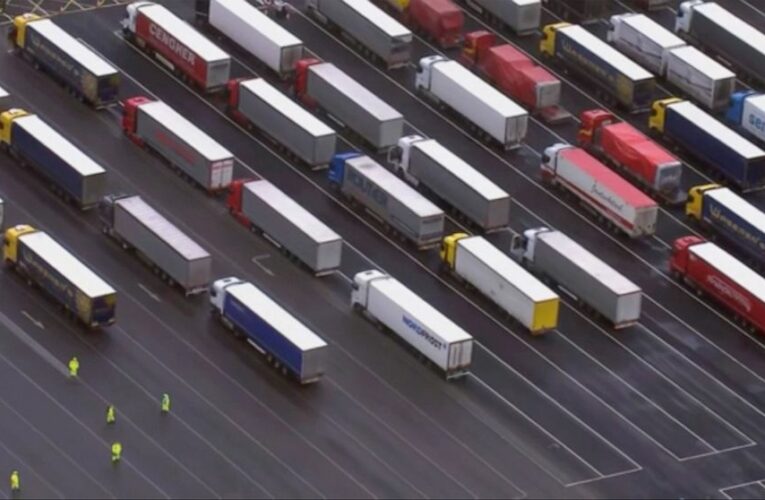 France lets some UK cargo, people in; huge backlog remains