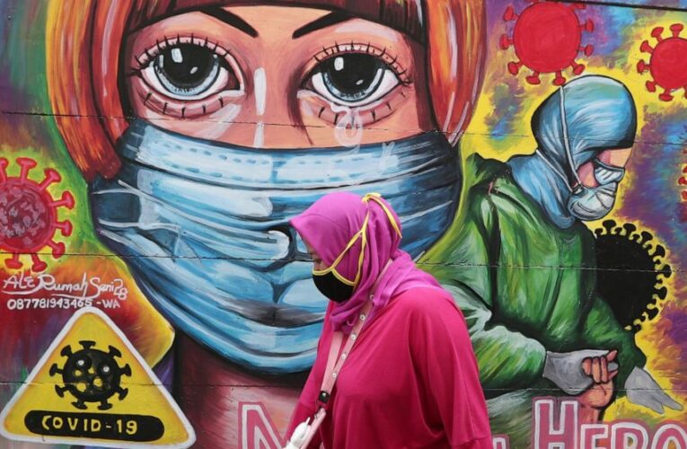 The Latest: France returns to 3 weeks between virus shots