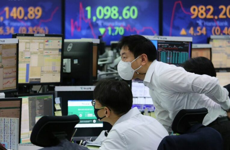 Stocks hold near records in mixed trading on Wall Street