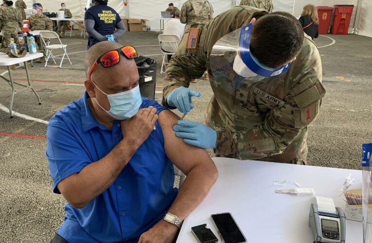 At a vaccination site in Miami, some wonder whether to receive the newly approved Johnson & Johnson vaccine or Pfizer one