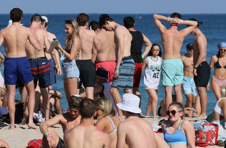 Don’t be fooled by packed beaches. The virus is still spreading rampantly, the White House chief medical adviser says.