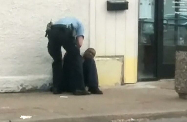 New cell phone video captured by a witness shows two officers standing above Floyd who is handcuffed, sitting on the ground