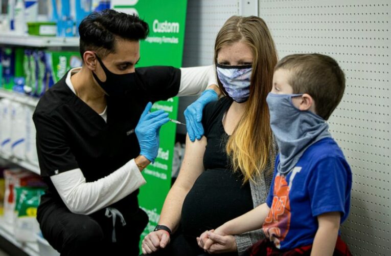 The Latest: CDC: Vaccinated people may meet without masks