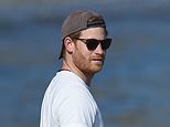 Prince Harry flips his baseball cap backwards for seaside stroll with dog in LA