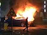 Rioters pelt police with 30 petrol bombs and torch three hijacked cars in Northern Ireland