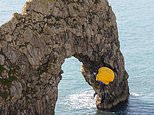 Parachutists throw themselves from top of Dorset’s Durdle Door