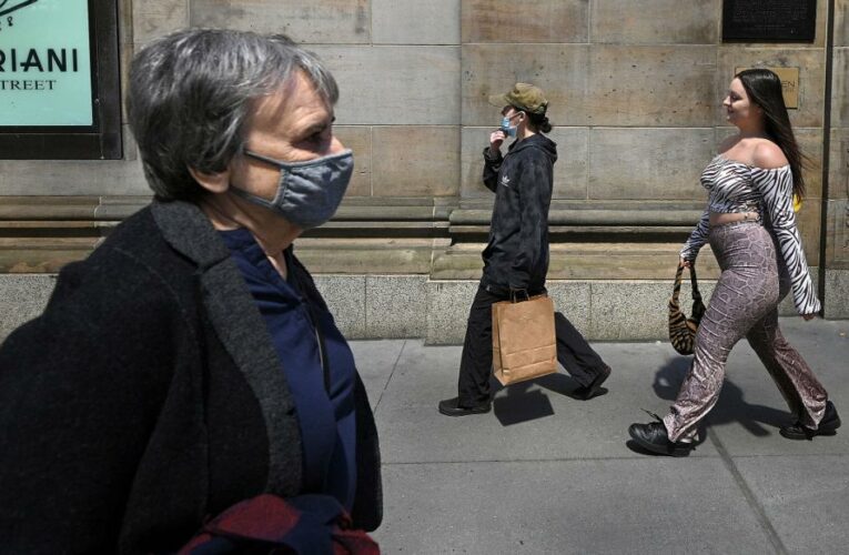 Some fully vaccinated Americans say they will keep wearing their masks outdoors, despite new guidelines