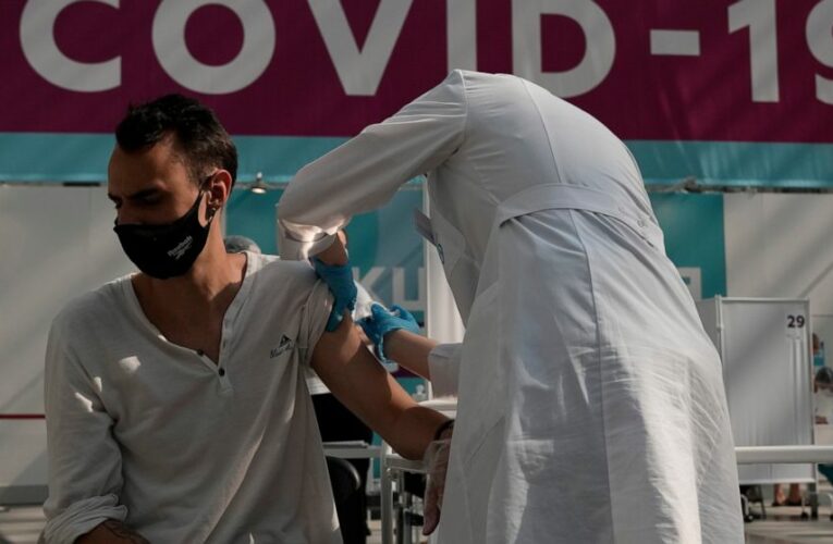 The Latest: Merkel urges Germans to get vaccinated