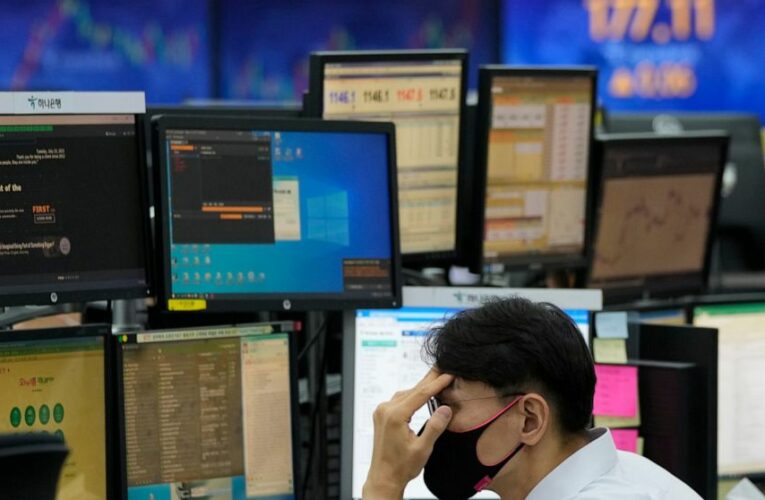 Stocks ease below recent records as earnings reports roll in