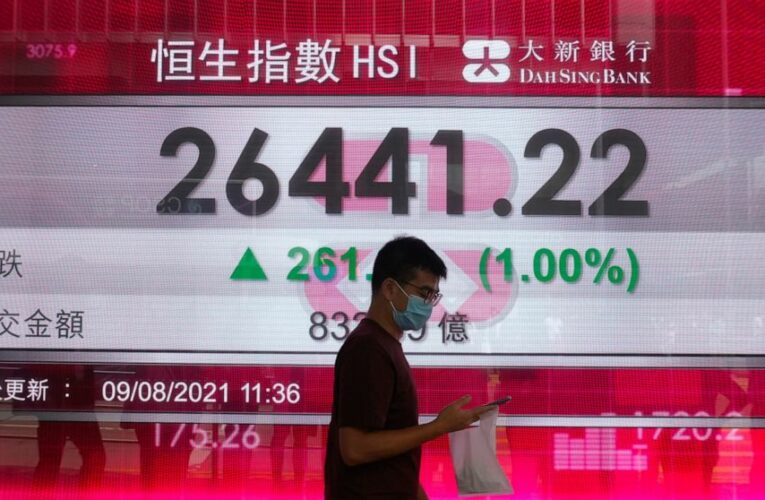 Stocks end a wobbly day lower, edging below recent records