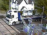 Silly trucker: Moment lorry driver REVERSES over level crossing