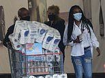 Panic buying is back! Shoppers queue to fill up trolleys with toilet roll and other essentials