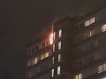 Emergency services race to tower block in southwest London as fire erupts in flat on the top floor