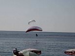 Shocking video captures moment paragliders COLLIDE in mid-air and plunge into the sea