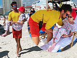 Lifeguards CARRY 95-year-old woman to beach chair when her wheelchair couldn’t move through the sand