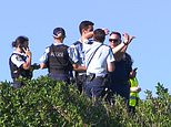 Swimmer is mauled to death by a 13ft great white at packed Sydney beach 