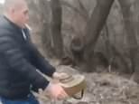 Symbol of Ukraine’s toughness: Man disposes of anti-tank mine while smoking CIGARETTE