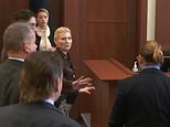Amber Heard recoils as she comes face to face with Johnny Depp who is blocked by court officials